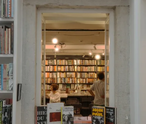 A cozy bookshop interior seen through a doorway.